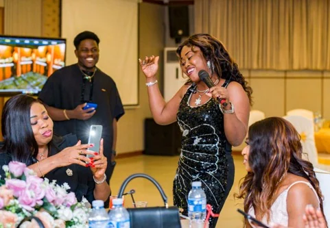 Celebration guest speaking into a microphone
